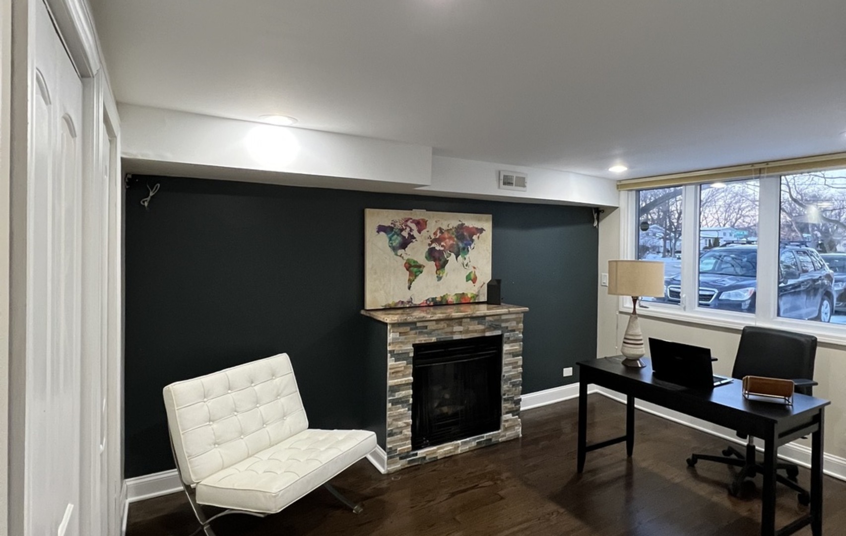 2933 Central Road Glenview, IL 60025 - Photo 25 of 38 a living room with furniture a fireplace and a large window