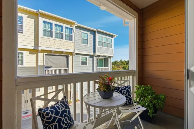a view of a chair and table in the balcony