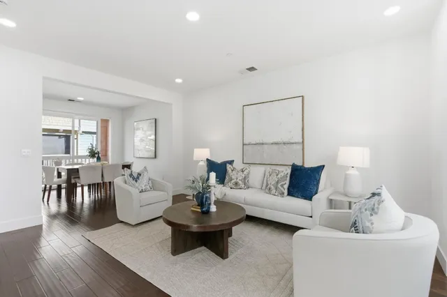 a living room with furniture and a potted plant