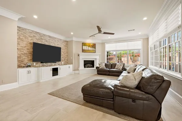 a living room with furniture fireplace and flat screen tv