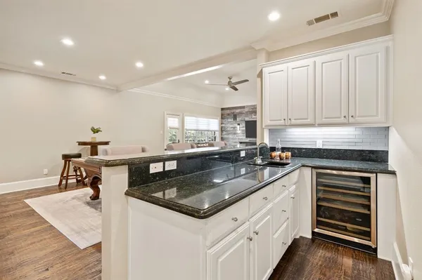 a kitchen with stainless steel appliances granite countertop a sink stove and cabinets