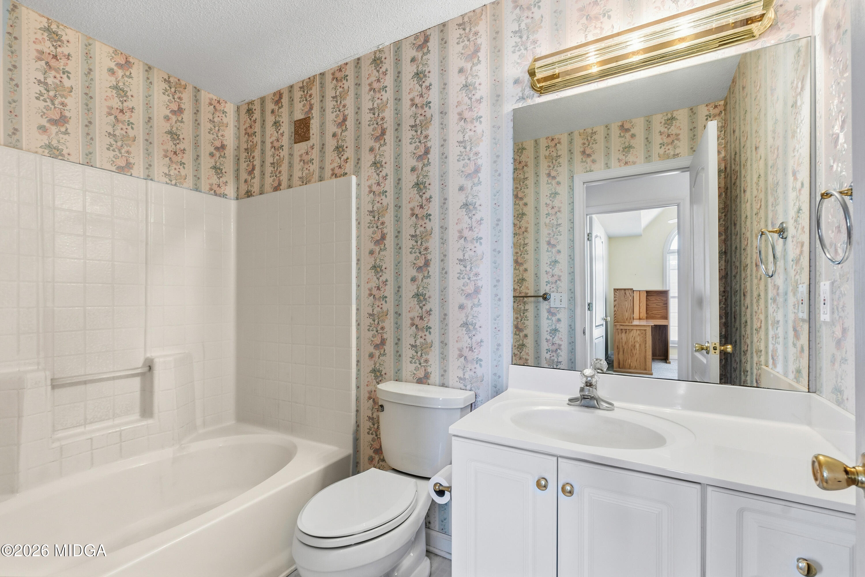 8278 Lower Thomaston Road Macon, GA 31220 - Photo 22 of 59 a bathroom with a sink a toilet a mirror a vanity and shower