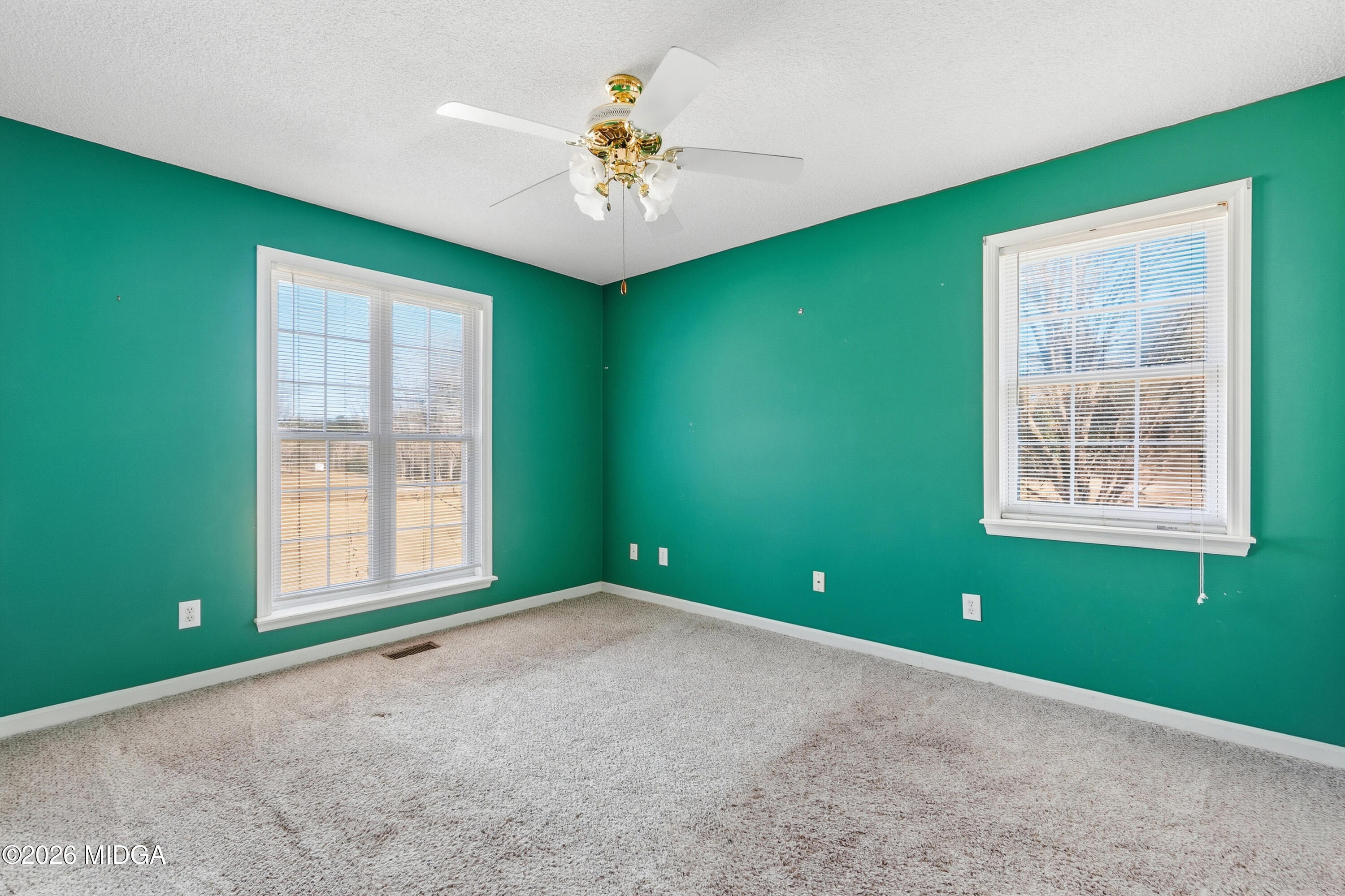 8278 Lower Thomaston Road Macon, GA 31220 - Photo 24 of 59 an empty room with a window and a ceiling fan