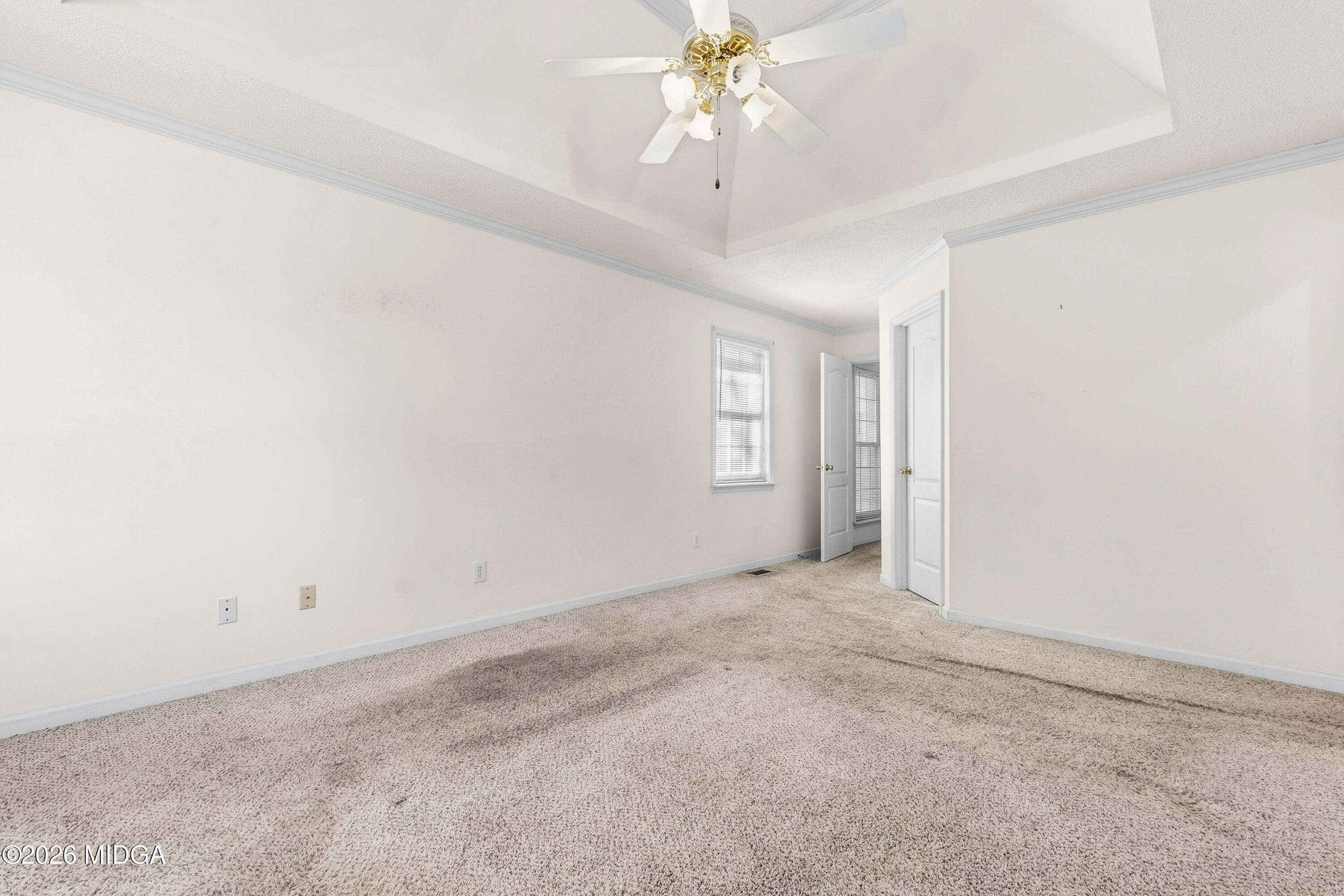 8278 Lower Thomaston Road Macon, GA 31220 - Photo 31 of 59 an empty room with a chandelier fan and windows