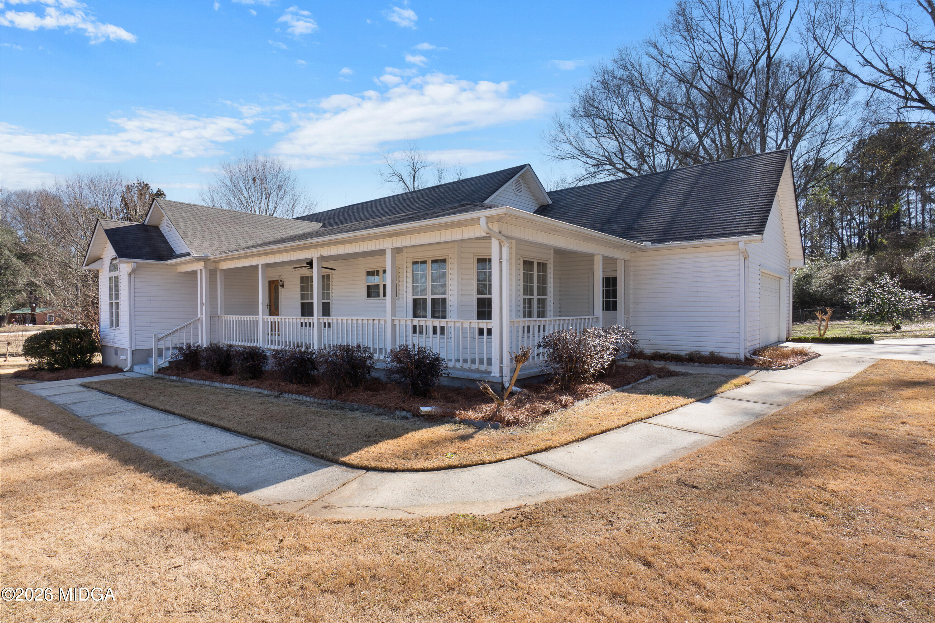 8278 Lower Thomaston Road Macon, GA 31220 - Photo 54 of 59 a view of a white house with a yard and large tree