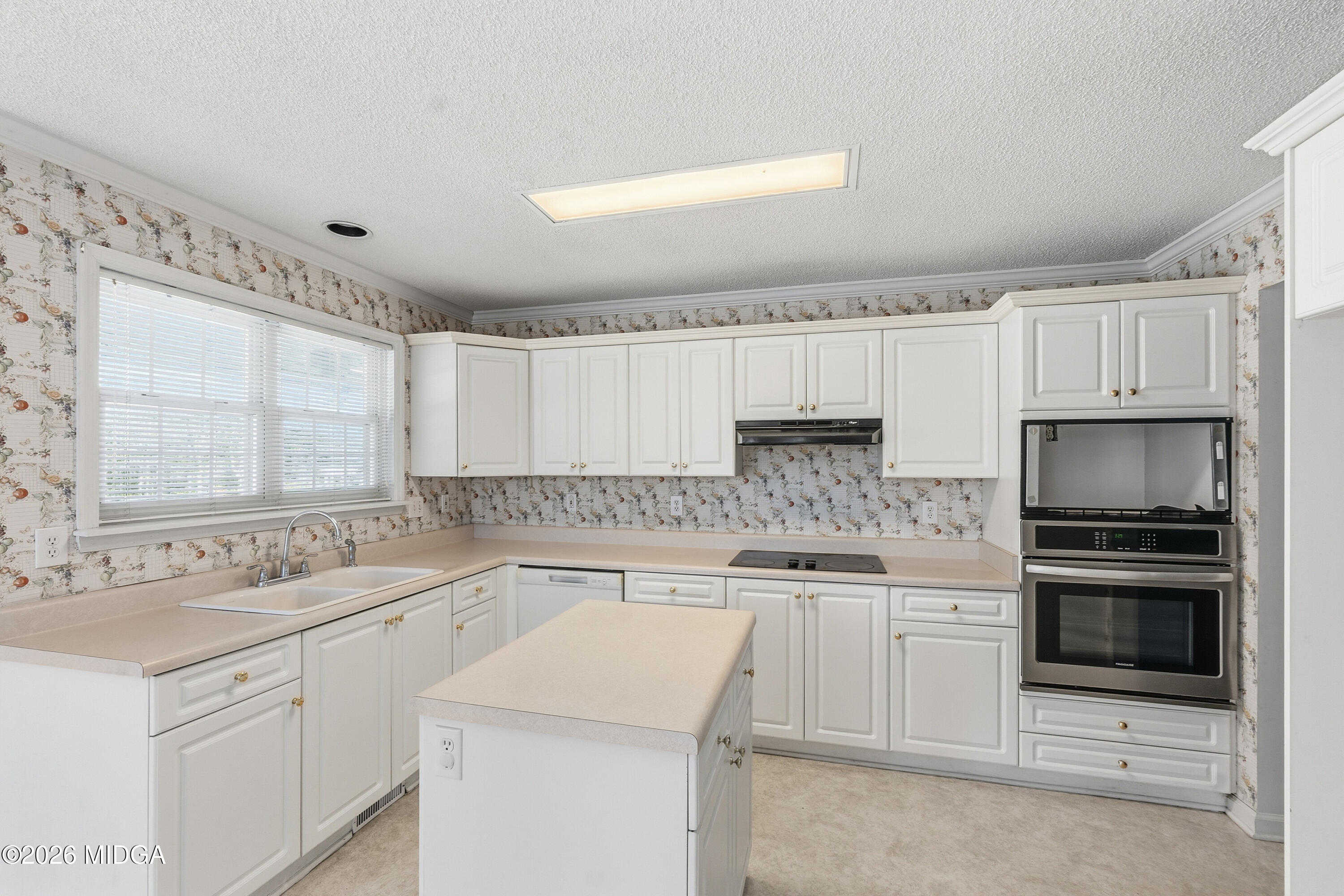8278 Lower Thomaston Road Macon, GA 31220 - Photo 8 of 59 a kitchen with a sink stove and cabinets