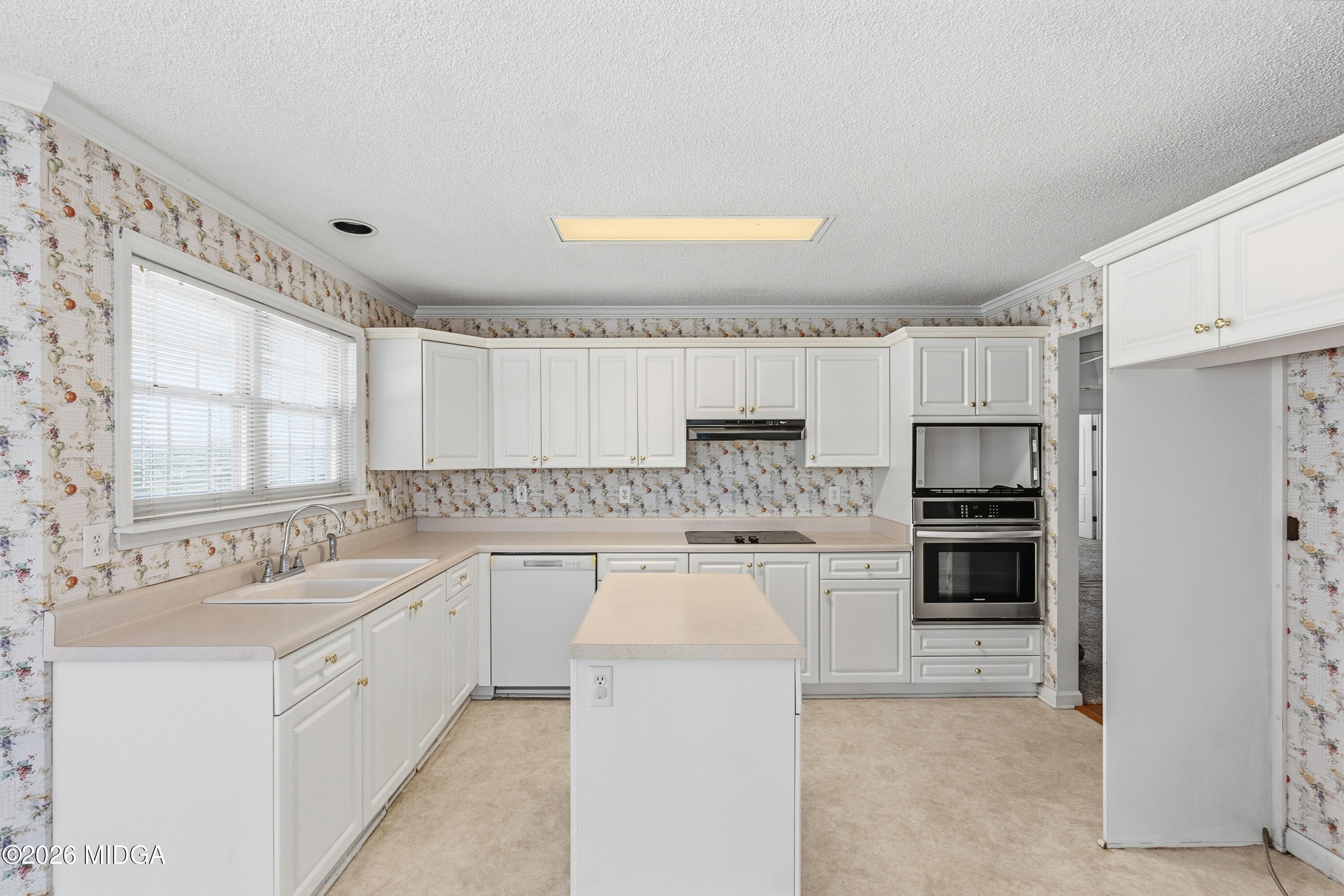 8278 Lower Thomaston Road Macon, GA 31220 - Photo 9 of 59 a large white kitchen with a stove top oven a sink and dishwasher