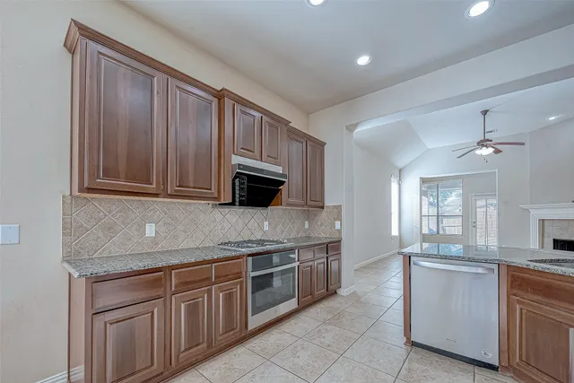 a stove top oven sitting inside of a kitchen