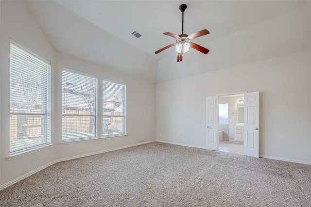 a view of an empty room with a window