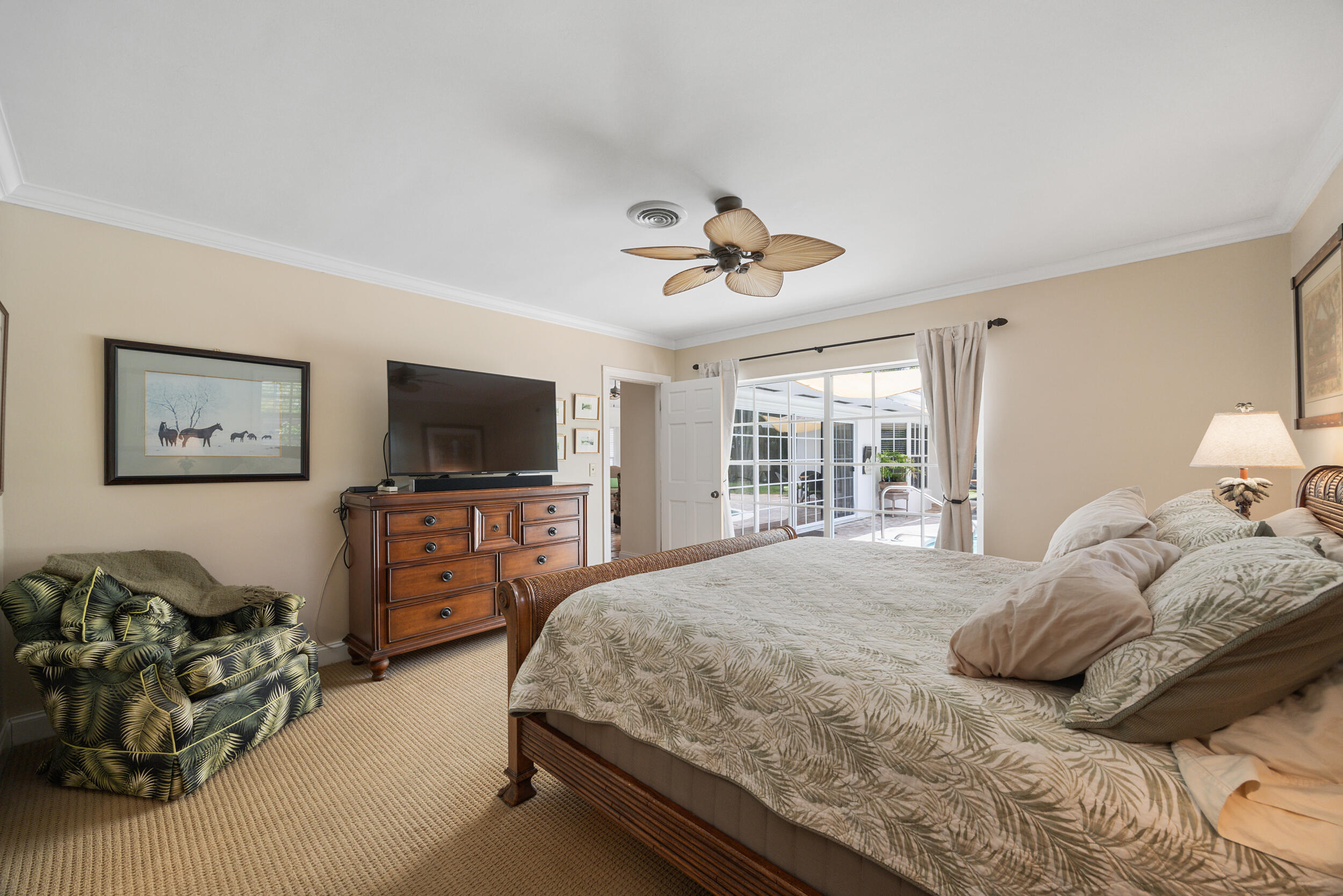 104 Fairview West Tequesta, FL 33469 - Photo 18 of 32 a bedroom with a bed and a flat screen tv