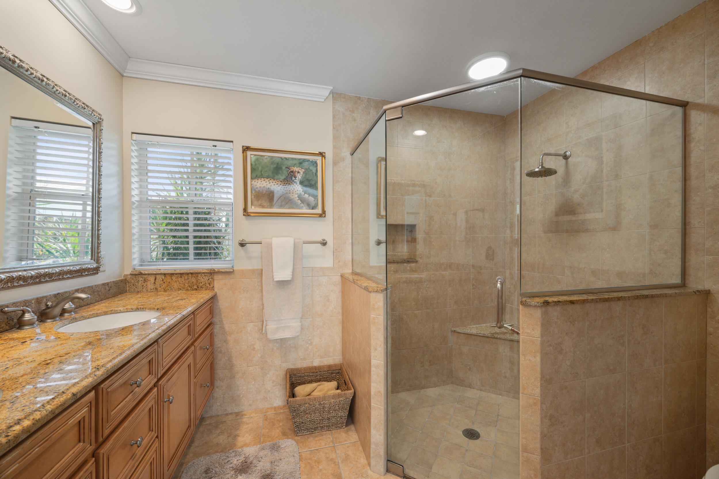 104 Fairview West Tequesta, FL 33469 - Photo 20 of 32 a bathroom with a shower sink vanity granite and a shower