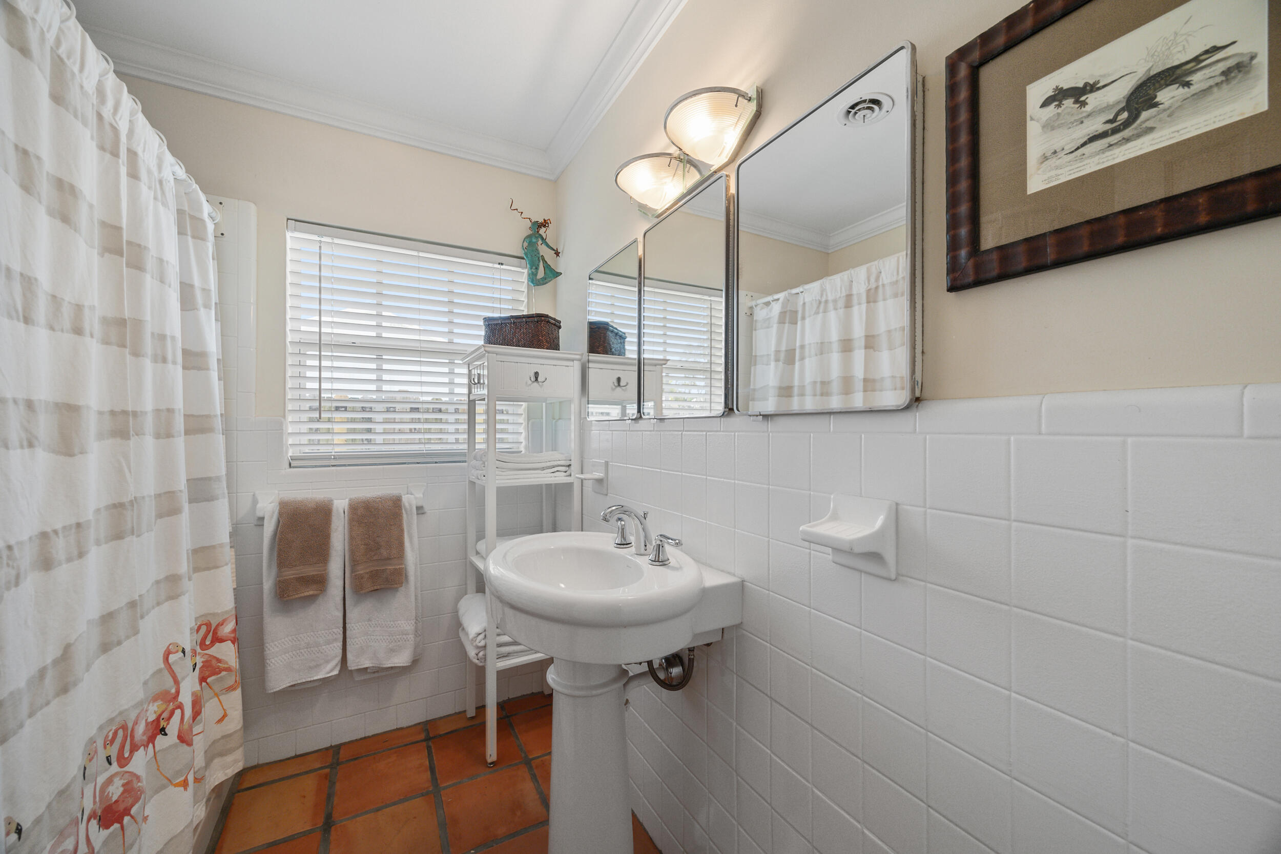 104 Fairview West Tequesta, FL 33469 - Photo 23 of 32 a bathroom with a sink a mirror and a shower
