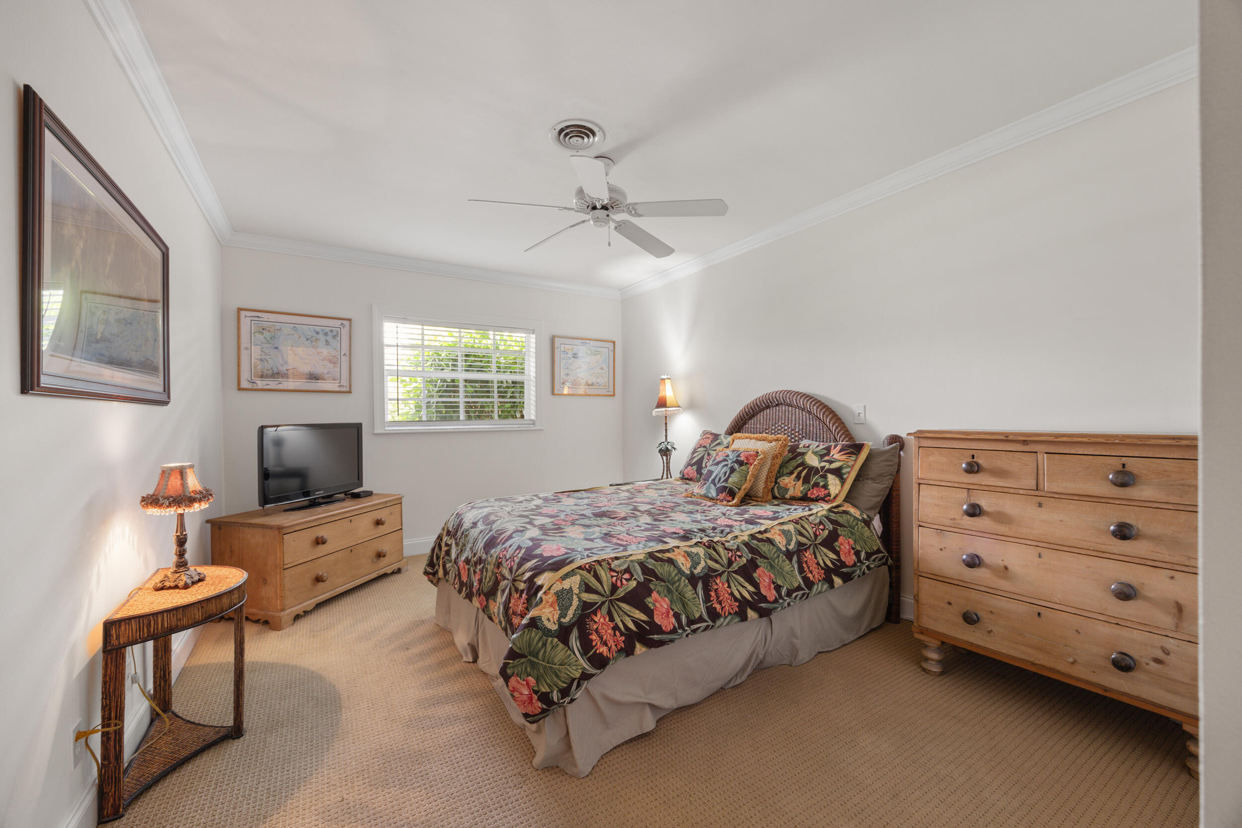 104 Fairview West Tequesta, FL 33469 - Photo 24 of 32 a bedroom with a bed and a chandelier