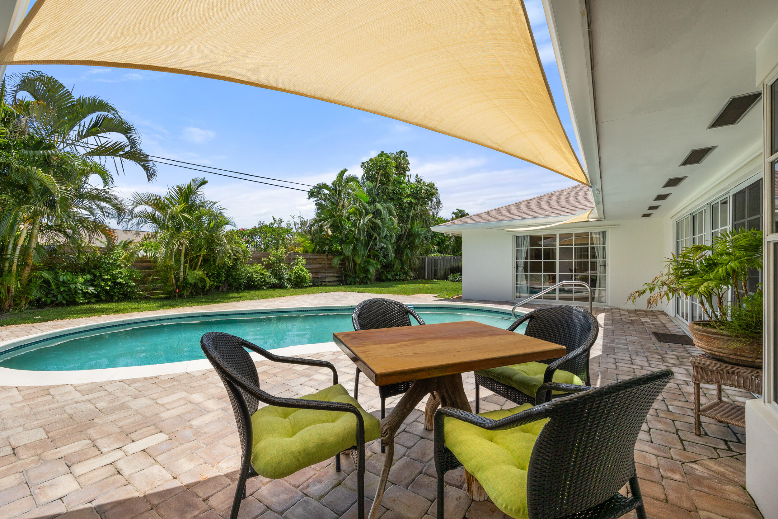 104 Fairview West Tequesta, FL 33469 - Photo 29 of 32 a backyard of a house with table and chairs