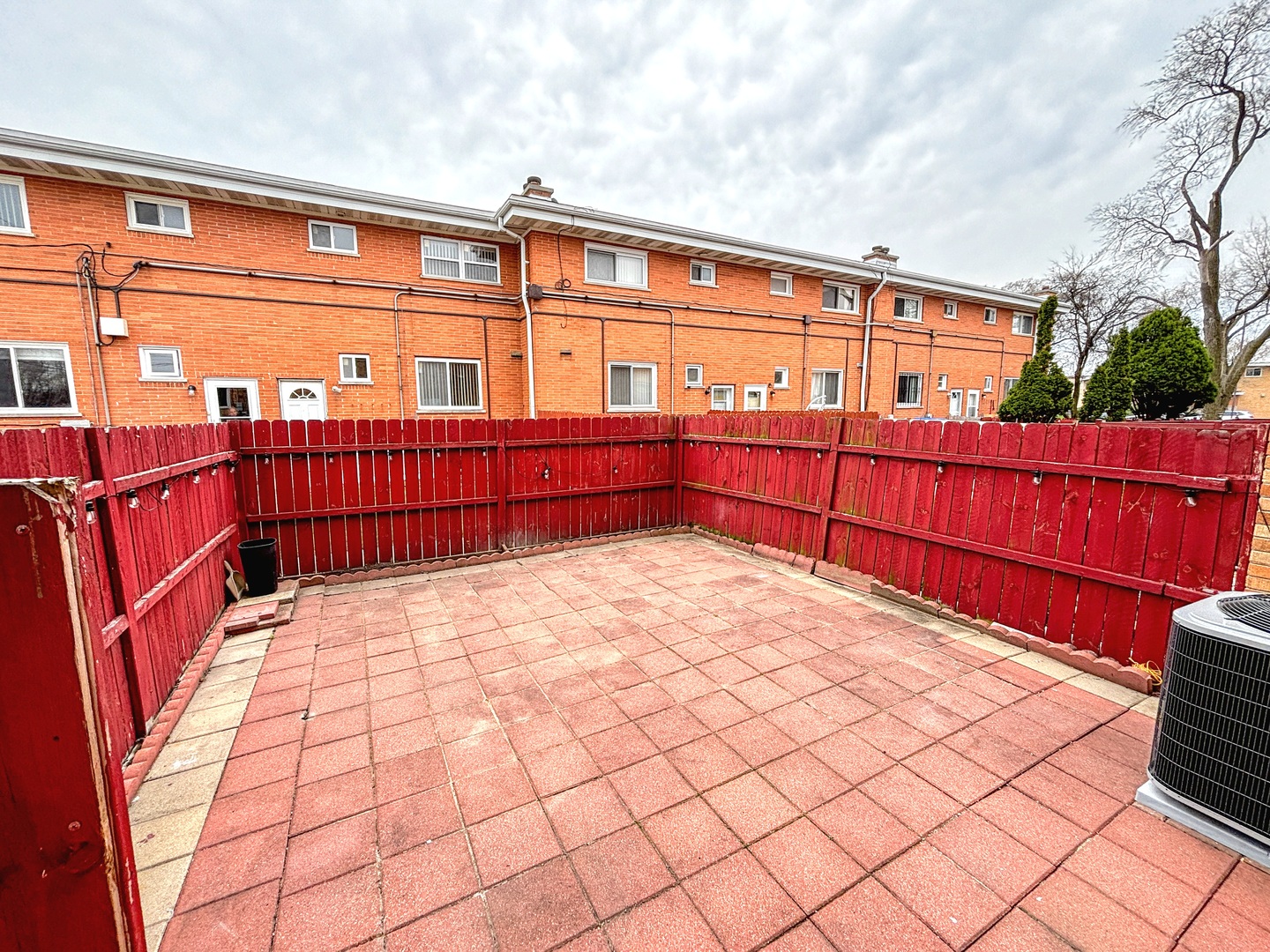 8664 Gregory Lane, Unit E Des Plaines, IL 60016 - Photo 14 of 15 a view of a blue building with wooden fence