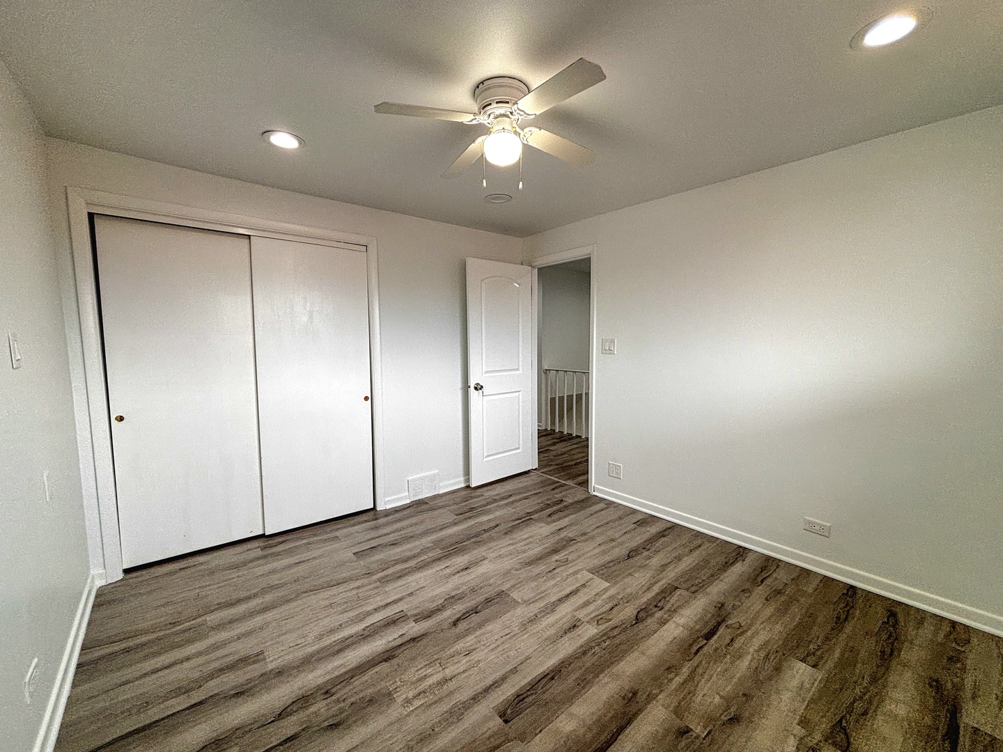 8664 Gregory Lane, Unit E Des Plaines, IL 60016 - Photo 7 of 15 a view of an empty room with wooden floor