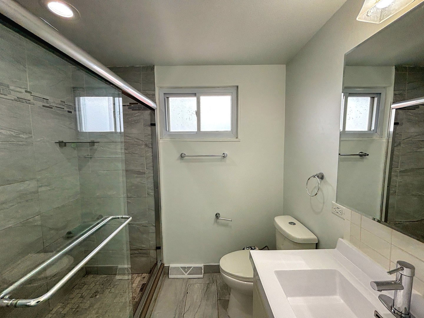 8664 Gregory Lane, Unit E Des Plaines, IL 60016 - Photo 10 of 15 a bathroom with a toilet sink and shower