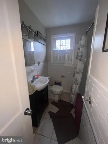 a bathroom with a sink toilet and mirror