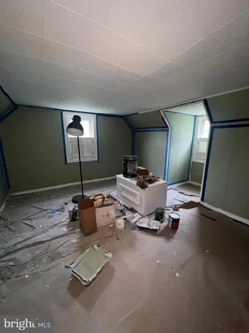 a room with gym equipment and a view of living room