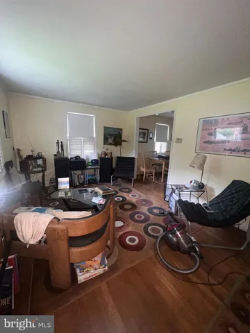 a room with furniture a rug and a window