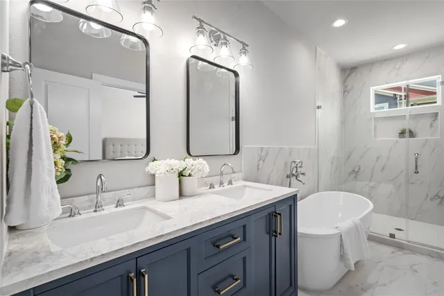 a bedroom with a bed potted plant on the dresser and a window