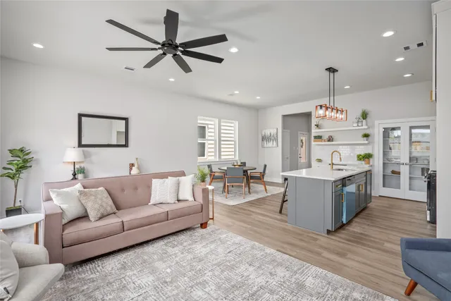a living room with furniture and a wooden floor