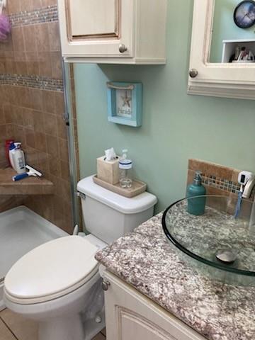 646 Southwest 33rd Cove Okeechobee, FL 34974 - Photo 19 of 19 a bathroom with a granite countertop toilet and a sink