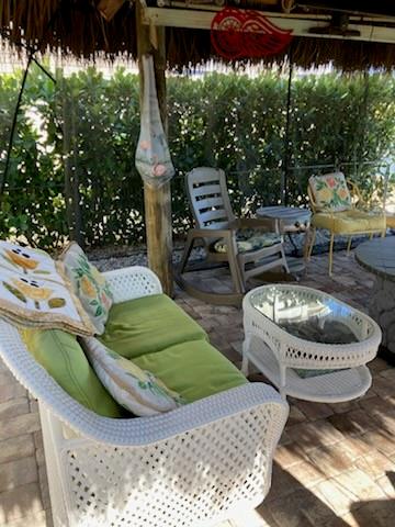 646 Southwest 33rd Cove Okeechobee, FL 34974 - Photo 9 of 19 a view of a swimming pool with lawn chairs and a fire pit