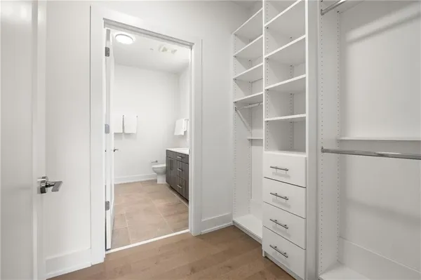 walk in closet with white cabinet