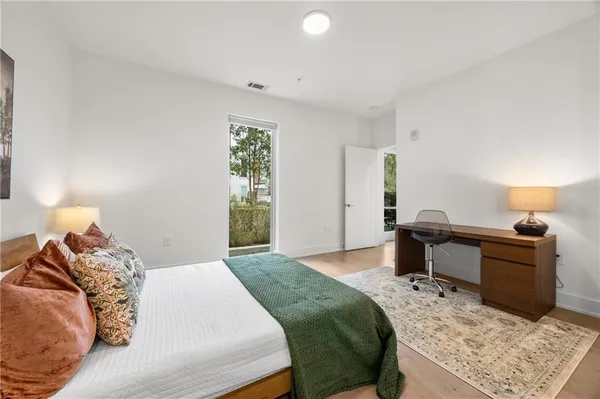 a bedroom with a bed and a lamp on table