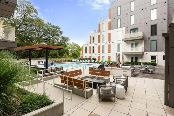 a view of a patio with chairs and tables with an umbrella