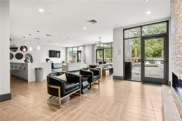 a living room with furniture large window and potted plants