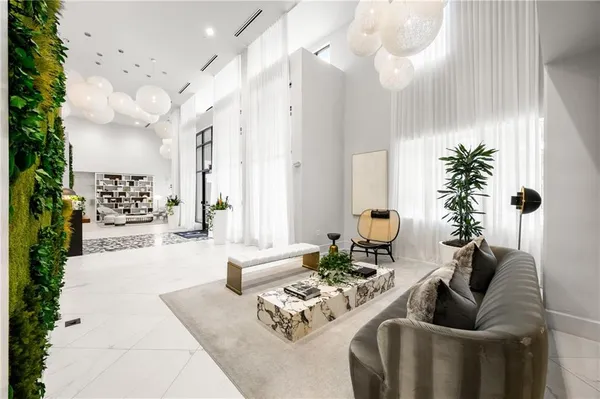 a living room with furniture flowers and a chandelier