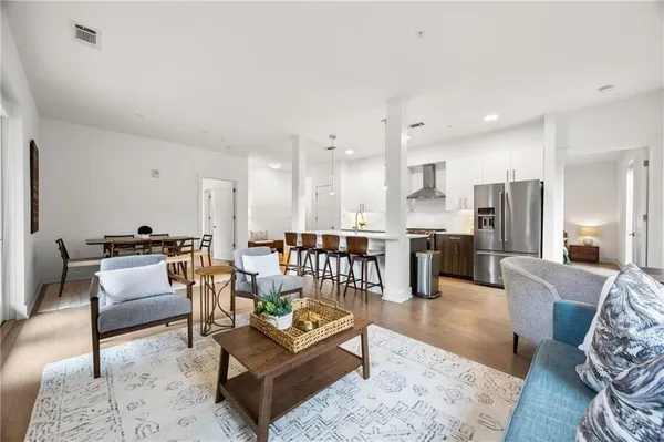 a living room with furniture and a view of kitchen