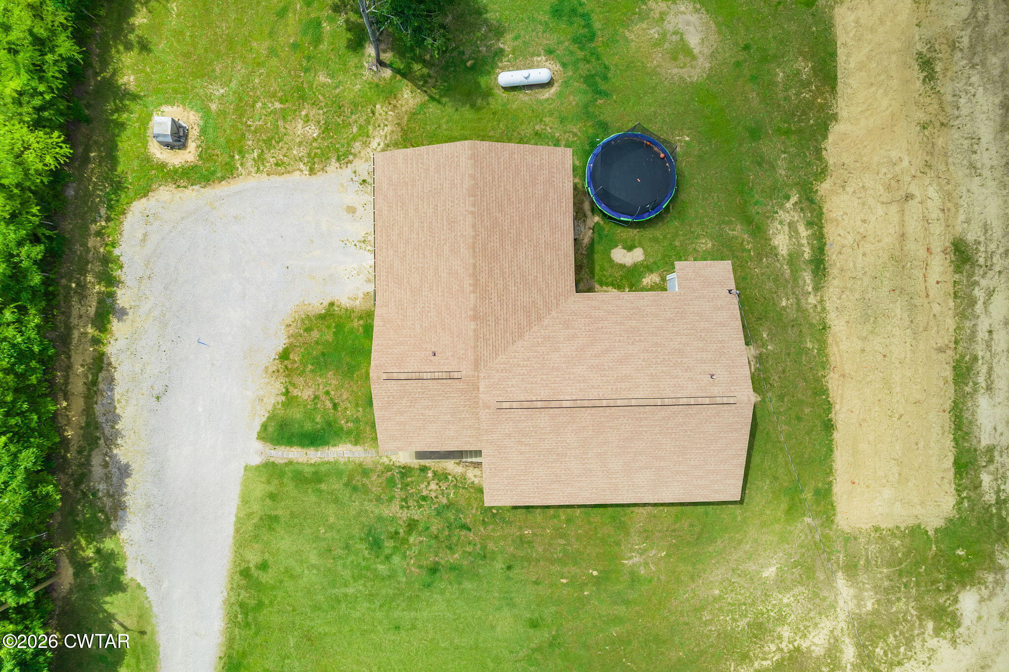 306 Jim Jackson Road Humboldt, TN 38343 - Photo 29 of 29 a backyard of a house with lots of green space and plants