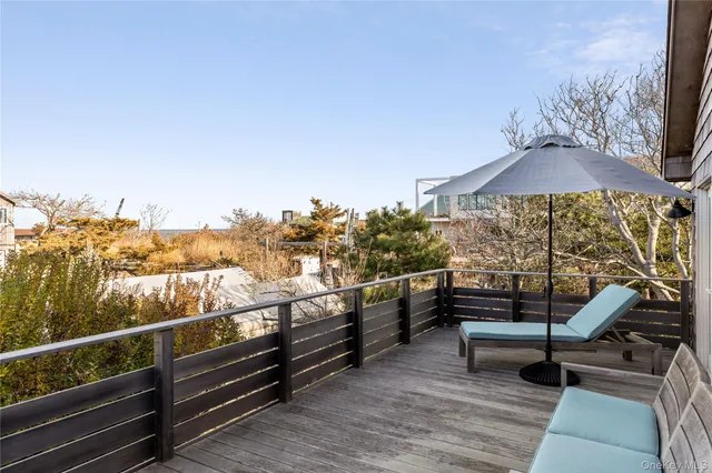 a view of a terrace with couches and sky view