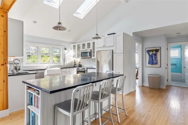 a kitchen with stainless steel appliances granite countertop a sink a stove and refrigerator