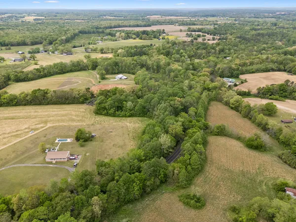 an aerial view of a houses with a yard