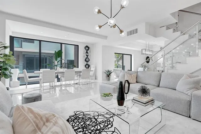 a living room with furniture and a chandelier