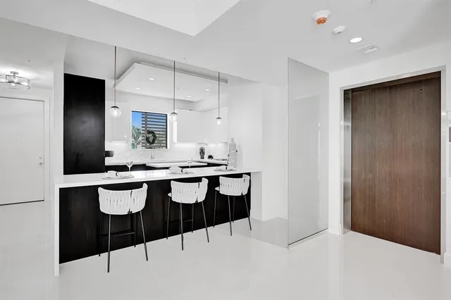 a kitchen with a table and chairs in it