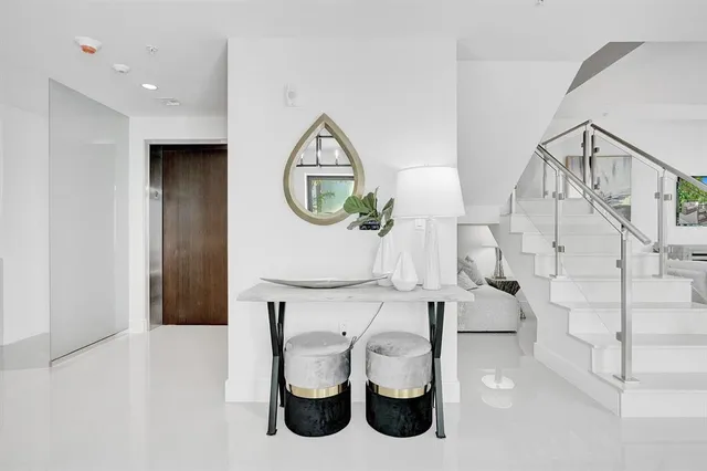 a kitchen with a sink a window and chairs