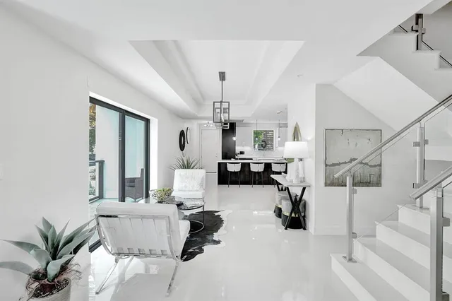 a kitchen with stainless steel appliances granite countertop a sink a stove and refrigerator