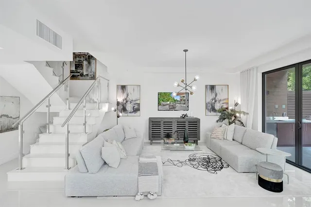 a bedroom with furniture and large windows