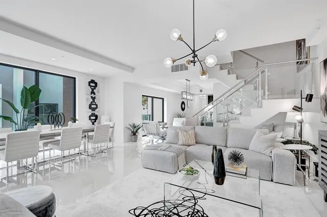 a view of kitchen with stainless steel appliances kitchen island granite countertop a living room