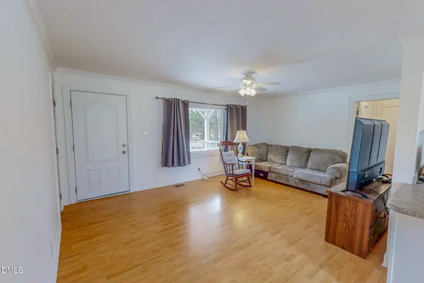 a living room with furniture and a chandelier