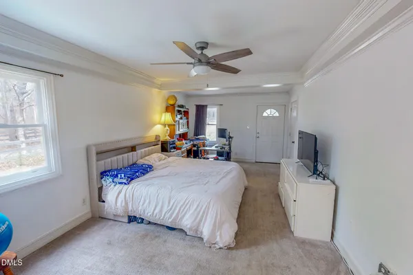 a bed room with a bed mirror and a window