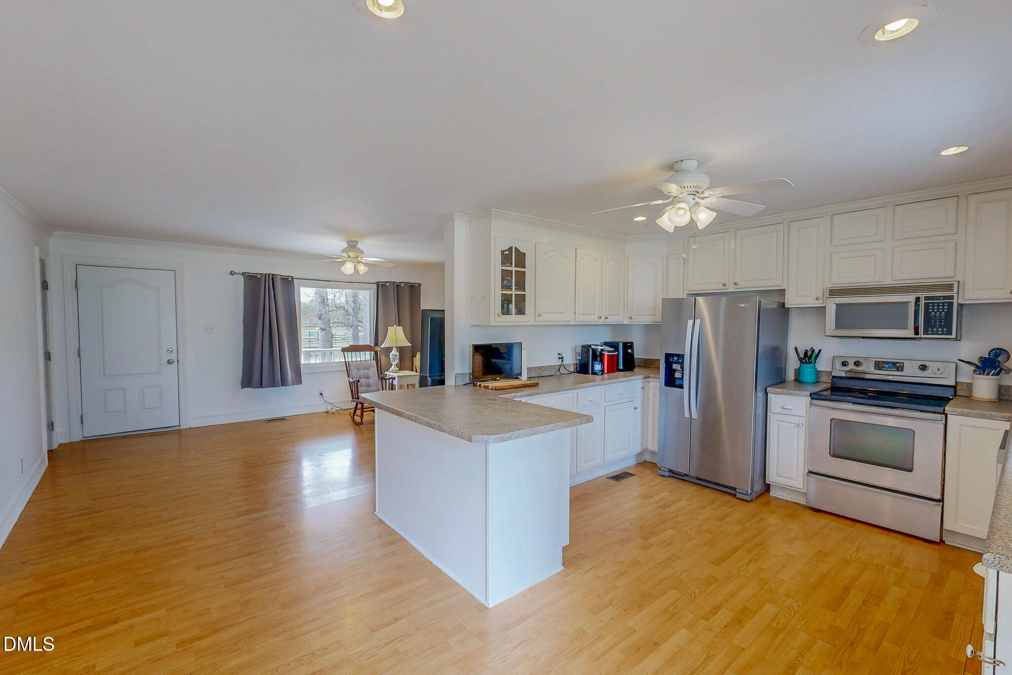 220 Bacon Road Rougemont, NC 27572 - Photo 19 of 42 a view of kitchen with furniture a refrigerator and a fireplace