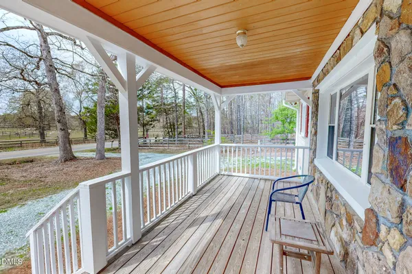 a view of a porch with wooden floor and outdoor space