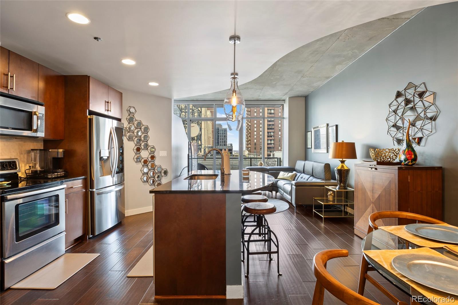 a living room with furniture wooden floor and flat screen tv