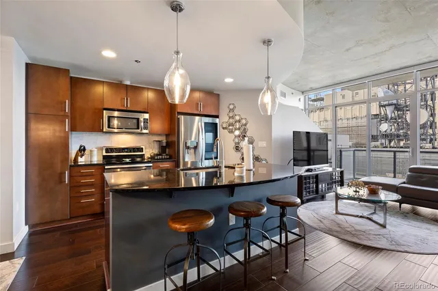 a kitchen with a counter space a sink and cabinets